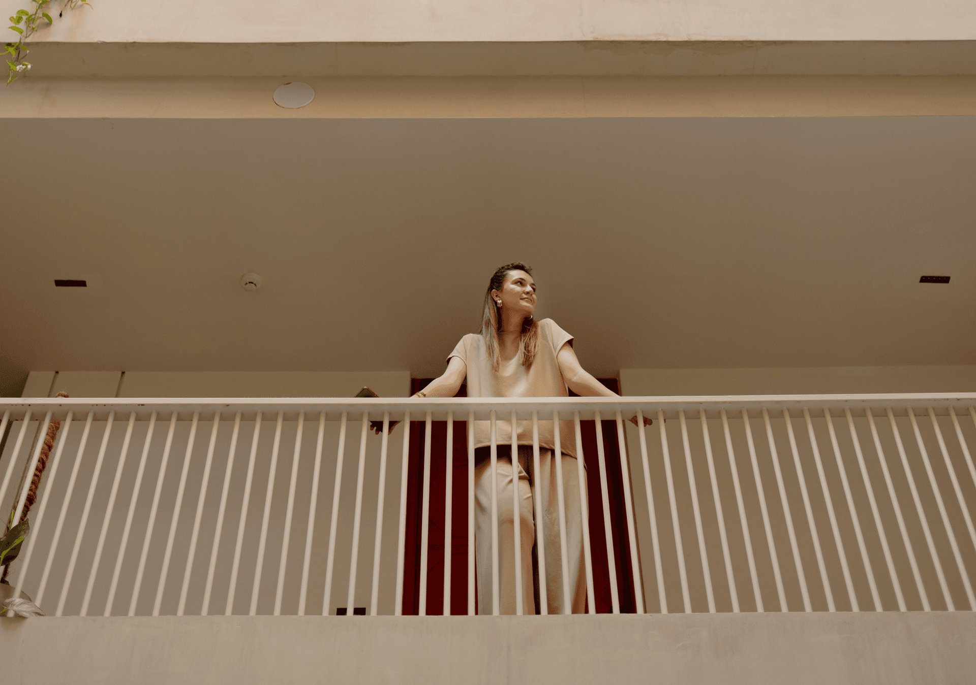 Woman standing on a private balcony at Cyrus One, capturing the hotel's spacious apartment-style accommodation near Islamabad Airport.