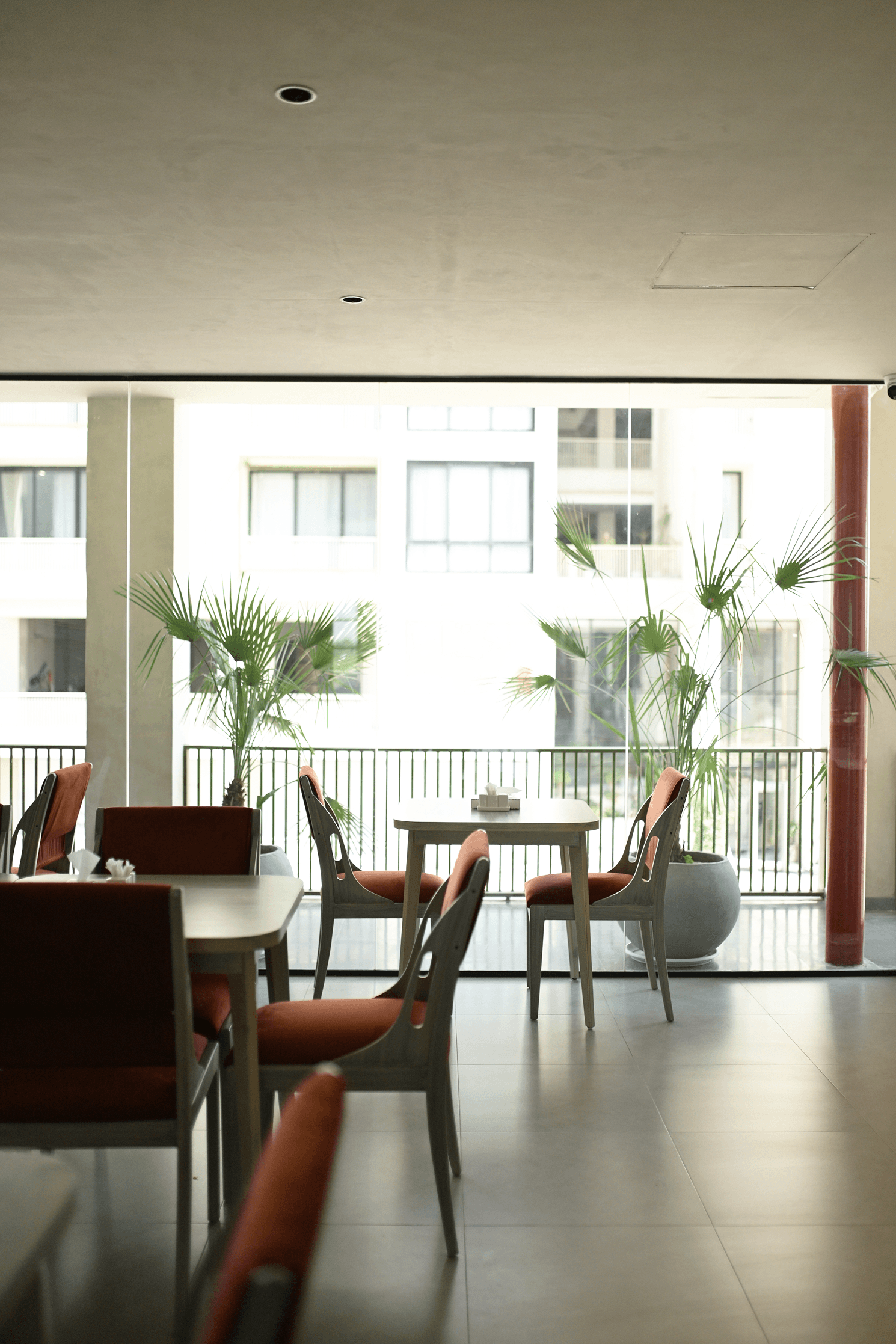 Balcony seating area with plants and city views at Cyrus One, part of the hotel's business-friendly facilities near Islamabad Airport.