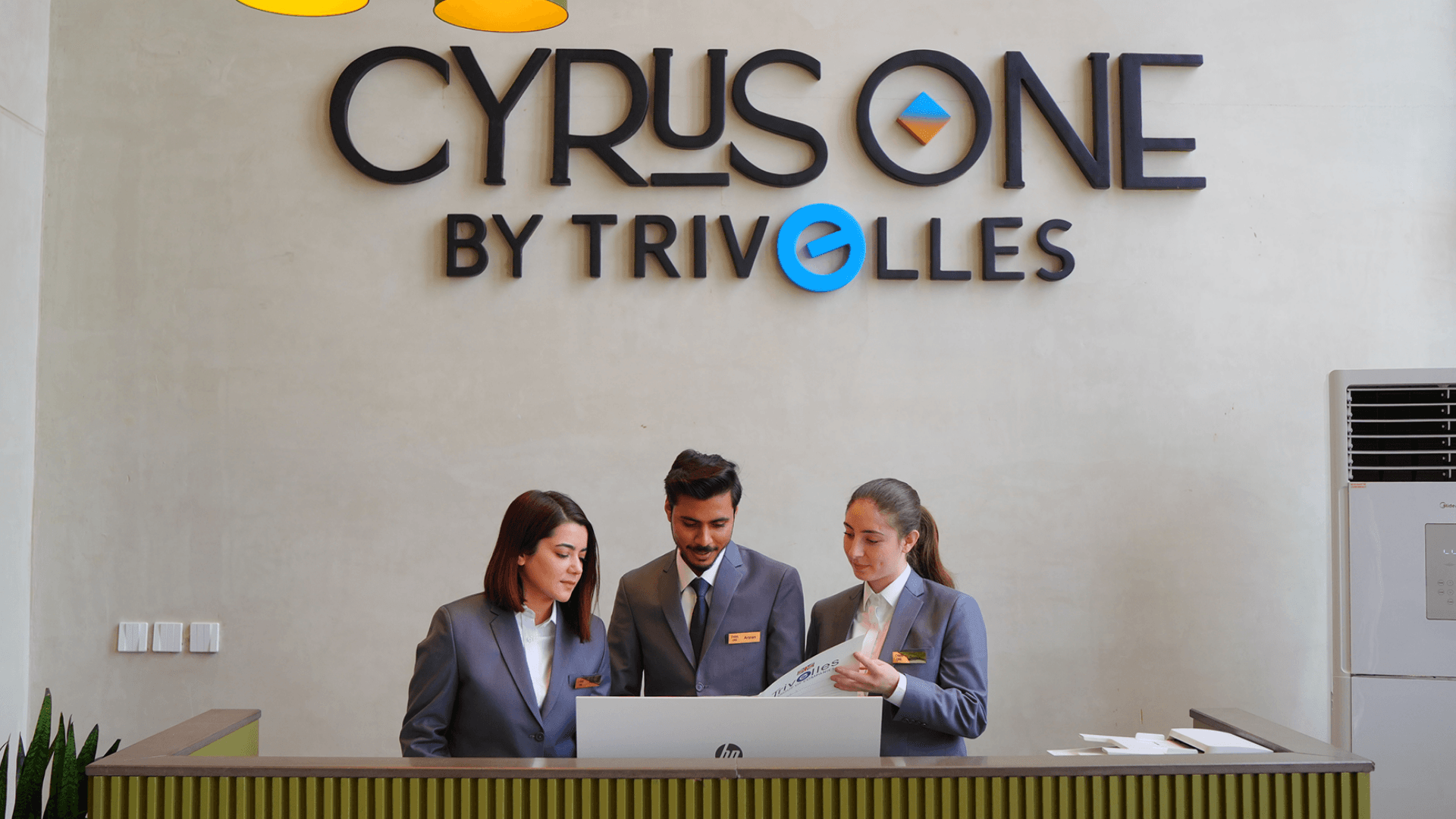 Cyrus One front desk team assisting guests with Islamabad travel and itinerary planning.